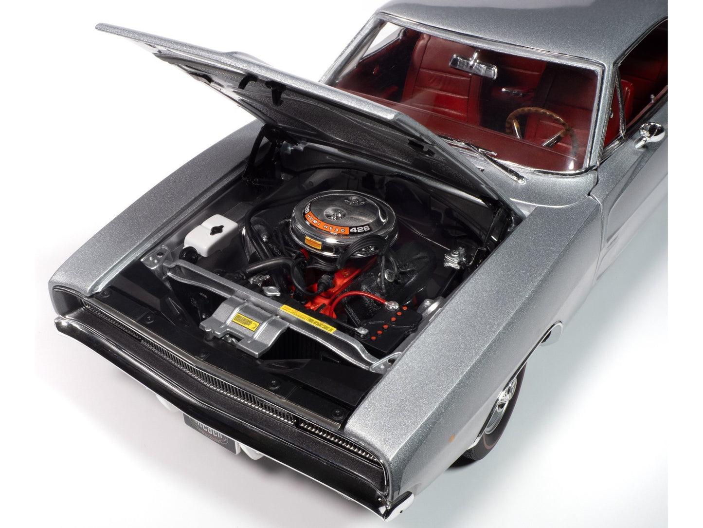 Model car with open hood showing engine details on a white background