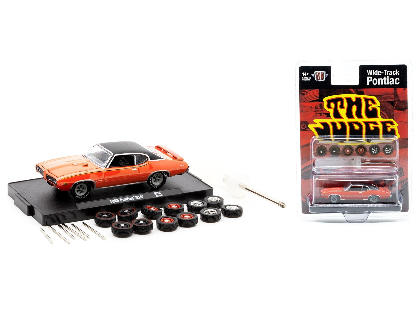 Model car kit with orange car, tires, and packaging on a white background