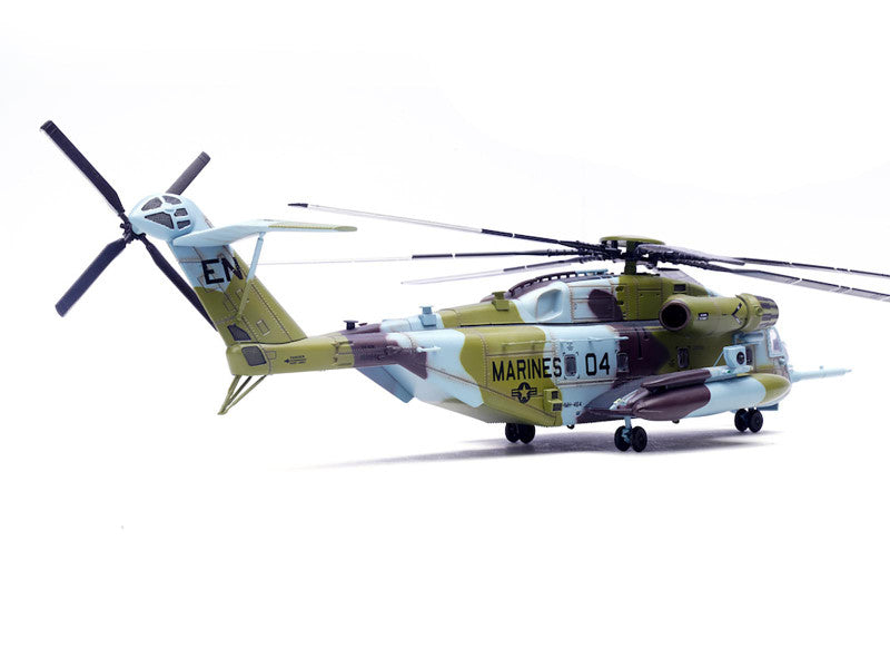 Model helicopter with camouflage design on a white background