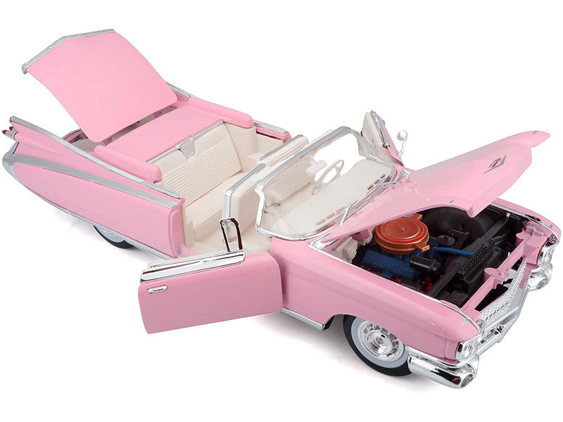 Engine compartment of pink Cadillac with door open