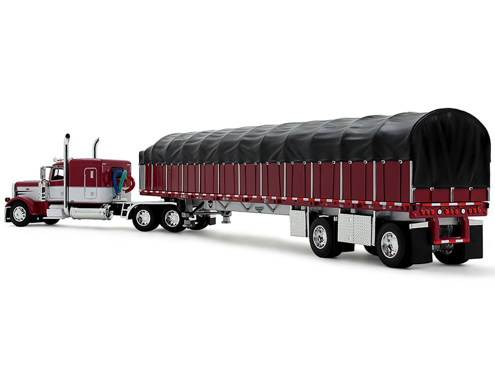Model of a red and black truck with a large trailer on a white background