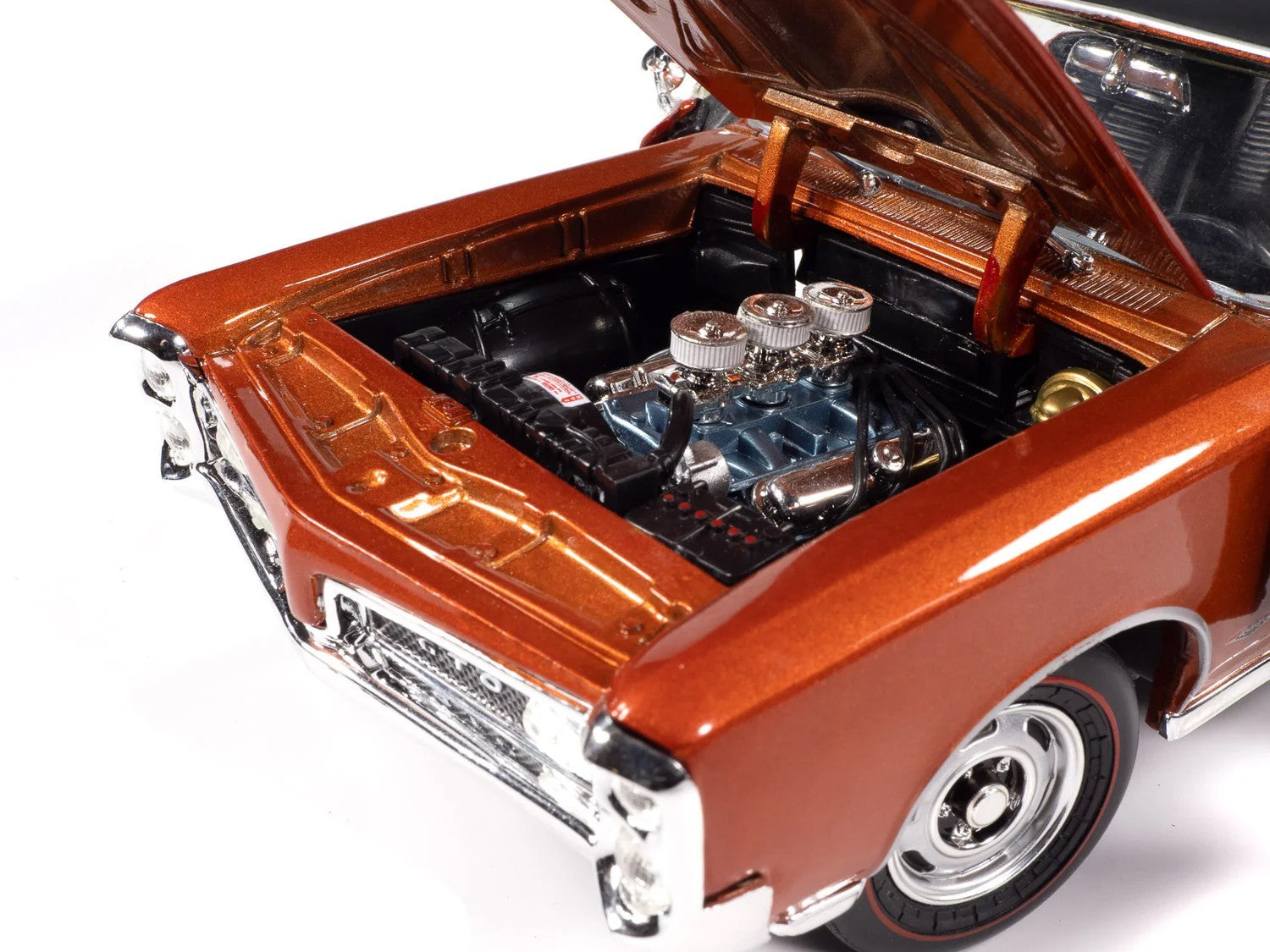 Model car with open hood showing engine details on a white background