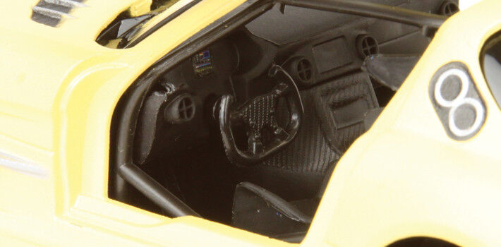 Close-up of a yellow model car's interior with visible branding.