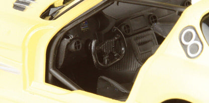 Close-up of a yellow model car's interior with visible branding.