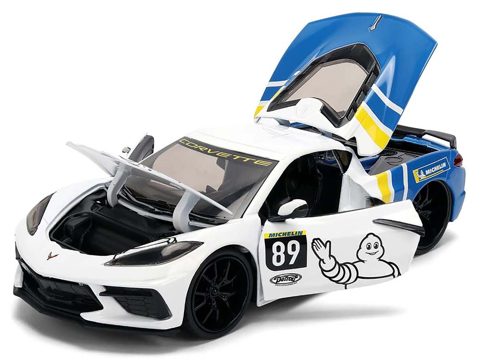 Model car of a Corvette with open doors on a white background