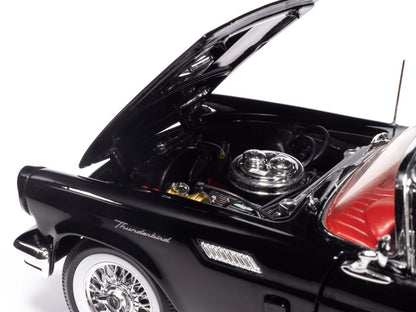 Black model car with open hood on a white background