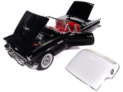 Black model car with open hood and a clear windshield on a white background