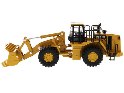 Model of a yellow Caterpillar loader on a white background