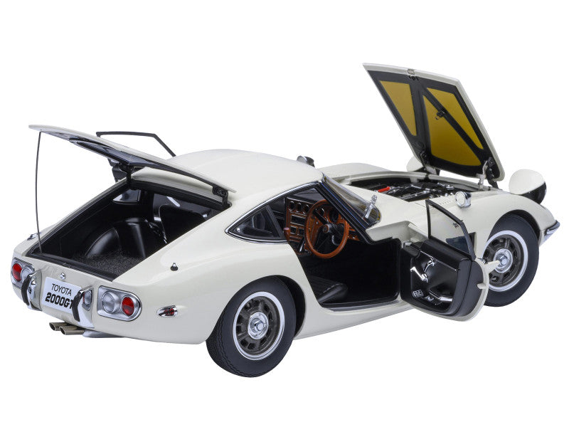 Model of a classic Toyota sports car with open doors and trunk on a white background