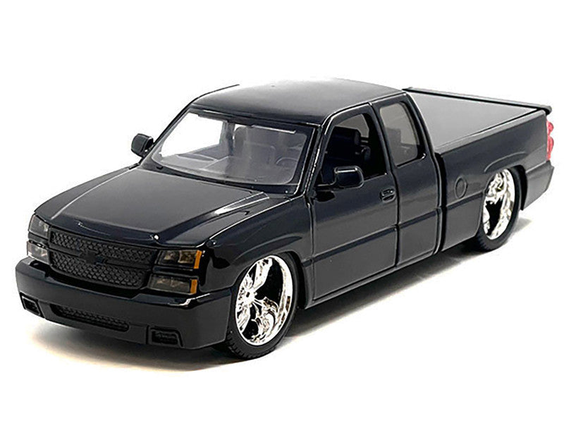 Model of a black pickup truck on a white background