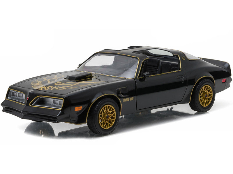 Black and gold model car on a white background