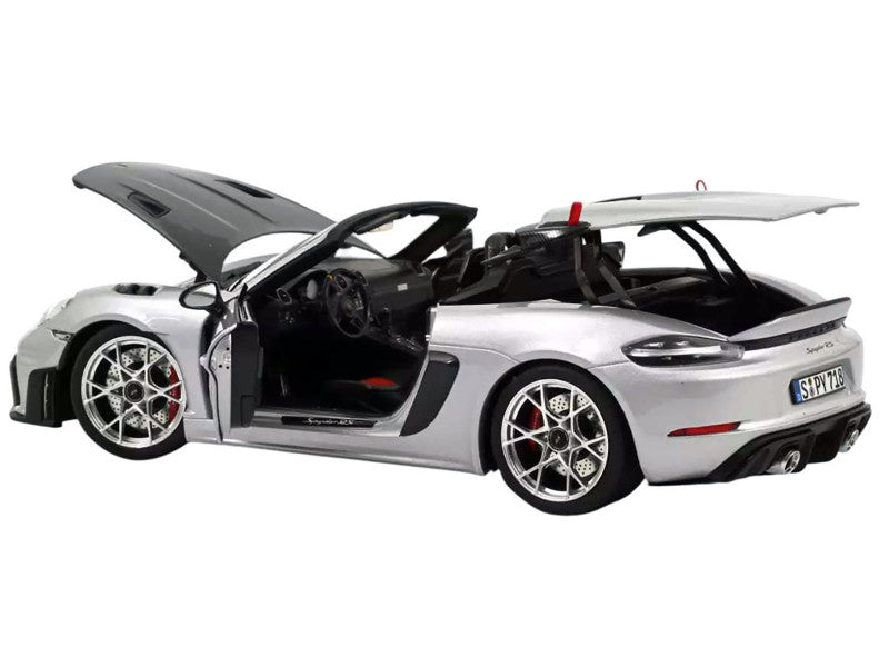 Model car of a sports car with open doors on a white background