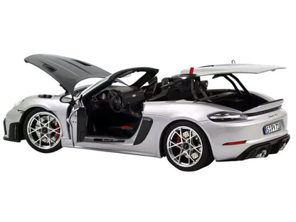 Model car of a sports car with open doors on a white background