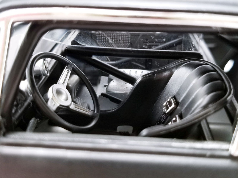 Close-up of a car's steering wheel and dashboard from inside the vehicle.