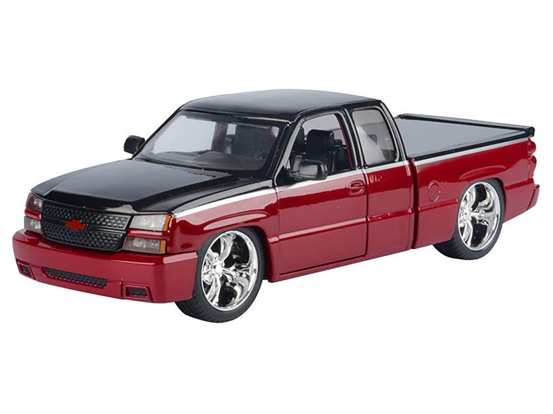 Model of a red and black pickup truck on a white background