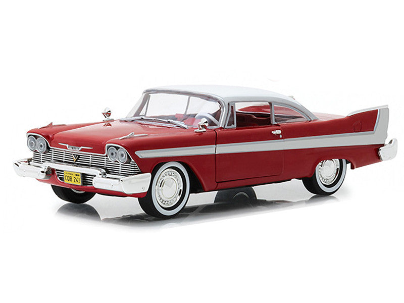 Model of a classic red and white car on a white background