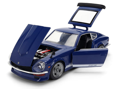 Blue model car with open doors and hood on a white background