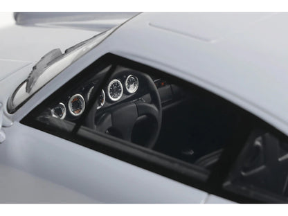 Close-up of a car's dashboard with steering wheel and gauges.