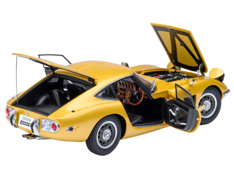 Yellow model car with open doors and hood on a white background