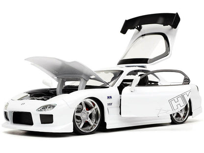 White sports car with open gull-wing doors on a white background