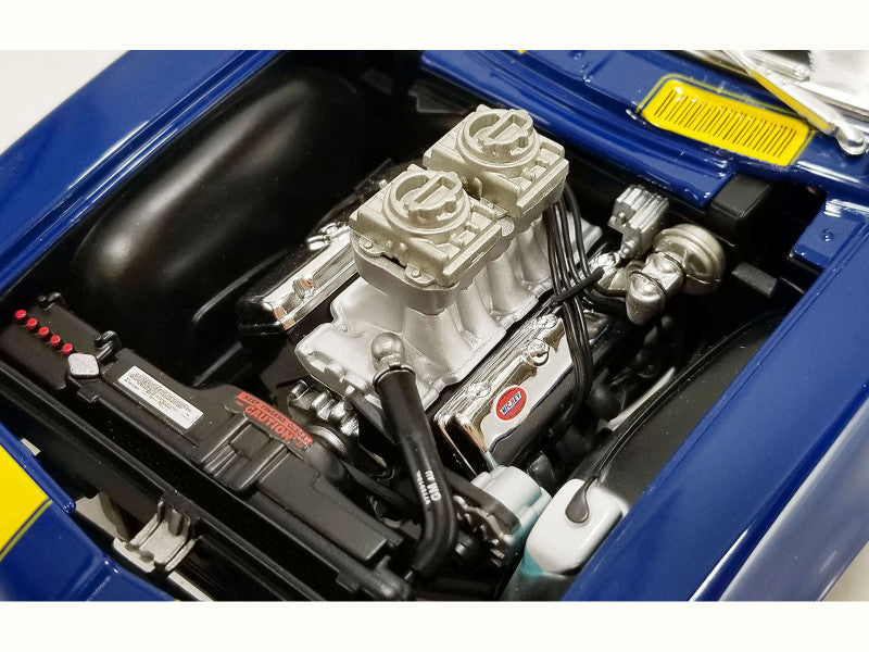 Car engine with visible components and a blue hood