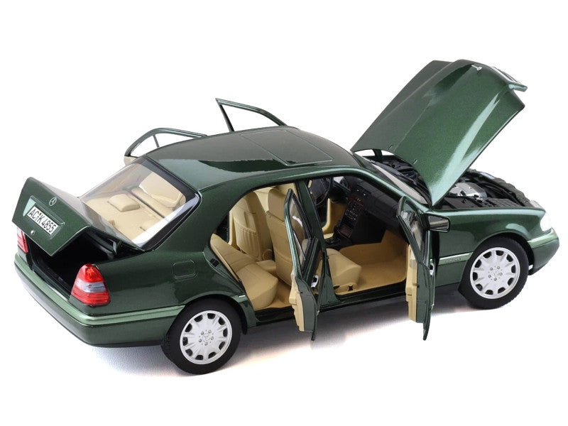 Green model car with open doors and trunk on a white background