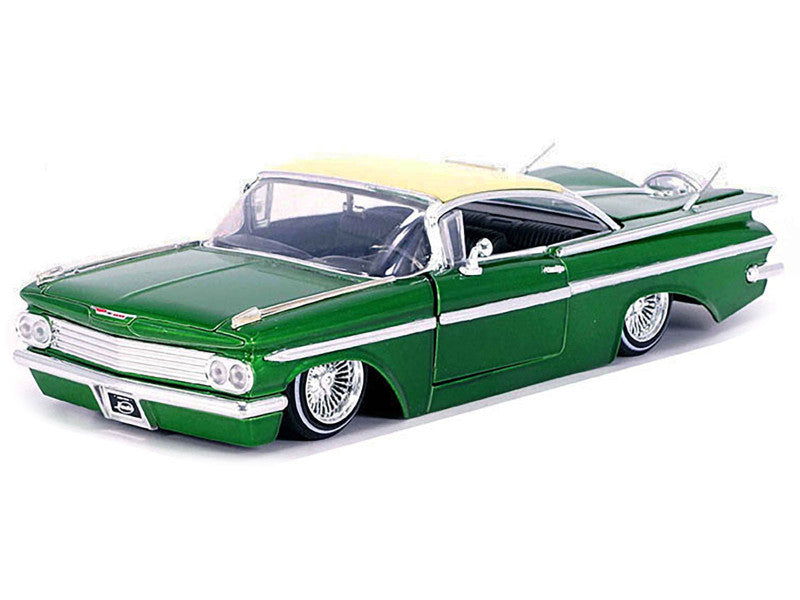 Model car with green body and yellow top on white background