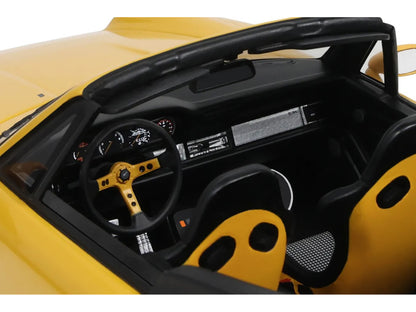 Close-up of a yellow car's interior with steering wheel and dashboard.