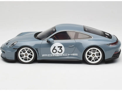 Model car of a Porsche with the number 63 on a white background