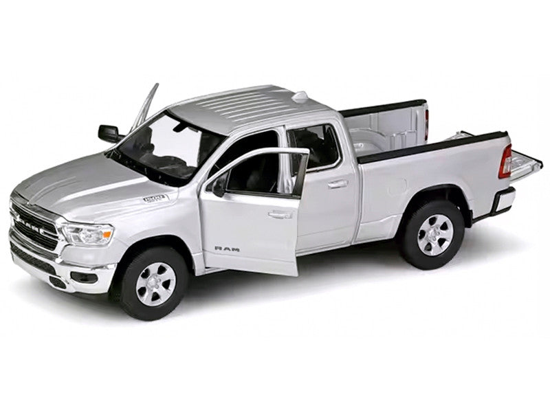 Model of a silver pickup truck with open door on white background