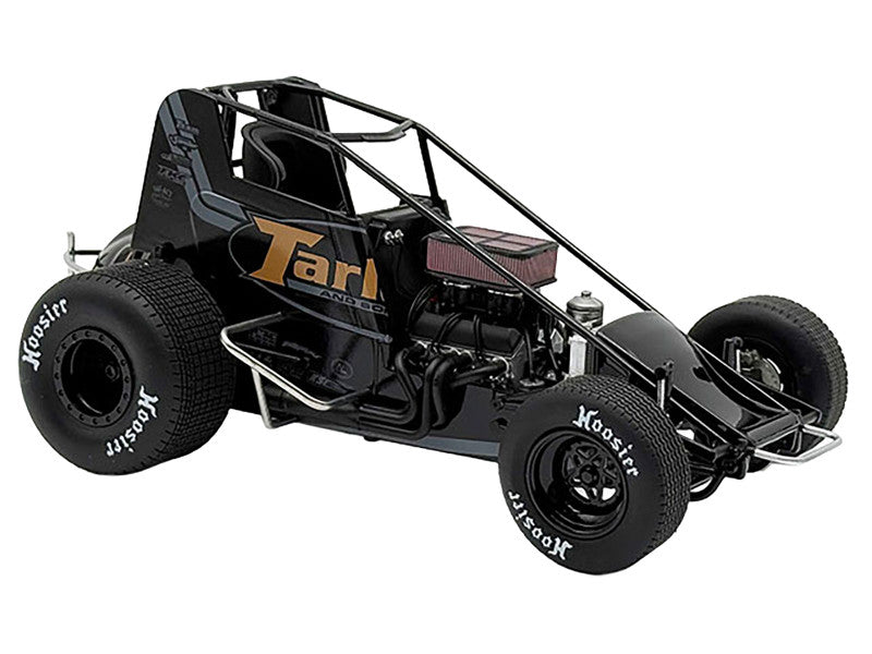 Model of a black race car with visible branding on a white background