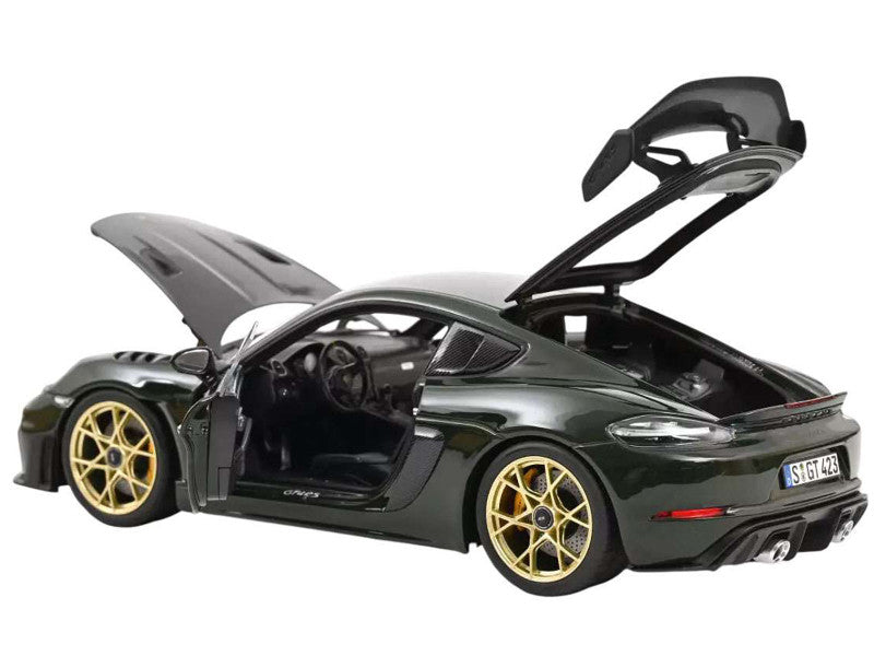 Green sports car model with open doors and hood on a white background