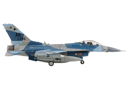 Model of a fighter jet with camouflage pattern on a white background