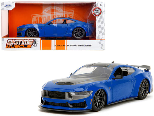 Blue model car in front of its packaging on a white background