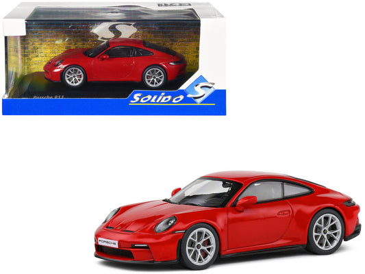 A diecast model of a Porsche 911 (992) GT3 Touring in Guards Red, made by Solido, displayed in its packaging.