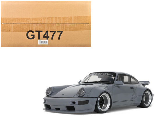 Model car next to a cardboard box with 'GT477' printed on it
