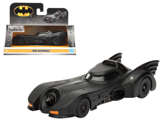 Black Batmobile toy car with packaging on a white background