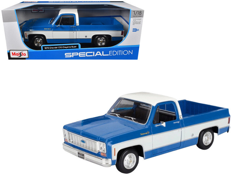 Blue and white model truck in a Maisto packaging on a white background