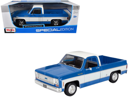 Blue and white model truck in a Maisto packaging on a white background