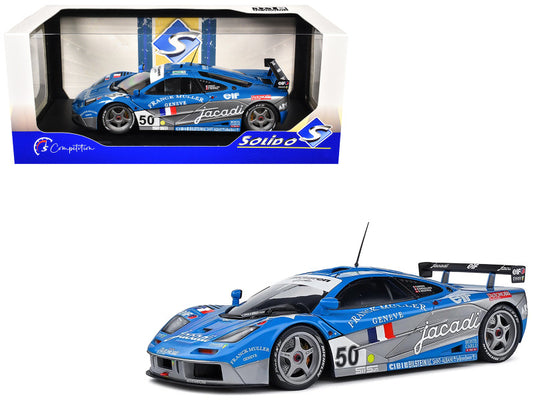 Model racing car with 'Jacadi' branding in front of its packaging