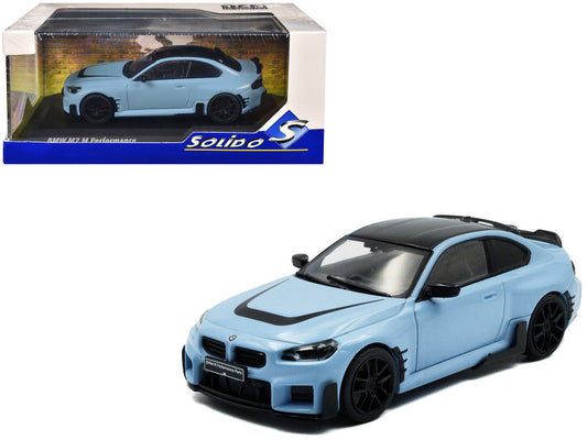 Light blue car model with black roof and black wheels, displayed in front of Solido packaging.