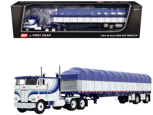 Model truck with blue and white trailer in front of its packaging
