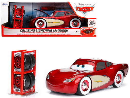 A diecast metal model of Lightning McQueen from the Disney Pixar movie Cars, with red color and silver detailing. The product is packaged in a box showing the car inside and has extra wheels displayed in a clear case.