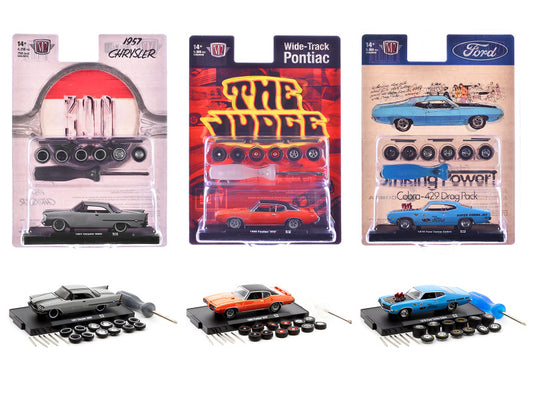Three model car kits in packaging with visible branding on a white background