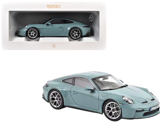 Light blue model car with Norev branding on a white background