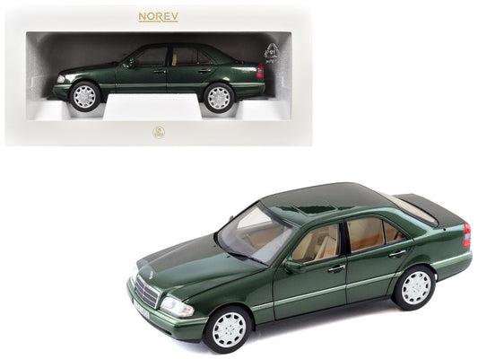 Green model car in a display case with Norev branding.
