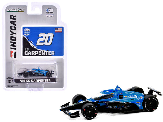 A diecast model of the Dallara IndyCar #20 Ed Carpenter in blue and black livery, with the car showcased in its packaging.