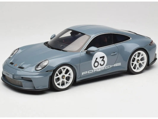 Model car of a Porsche with the number 63 on a white background