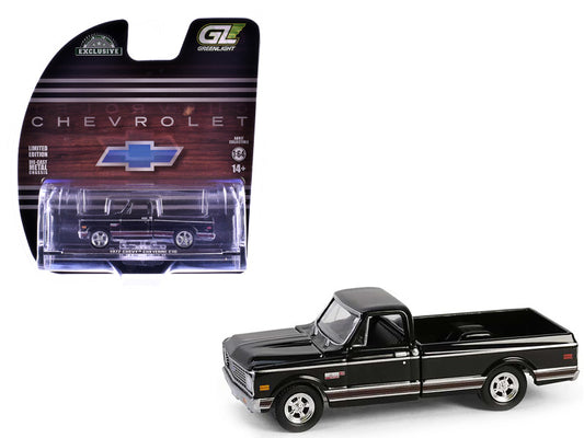 Black Chevrolet truck model in packaging with Chevrolet logo