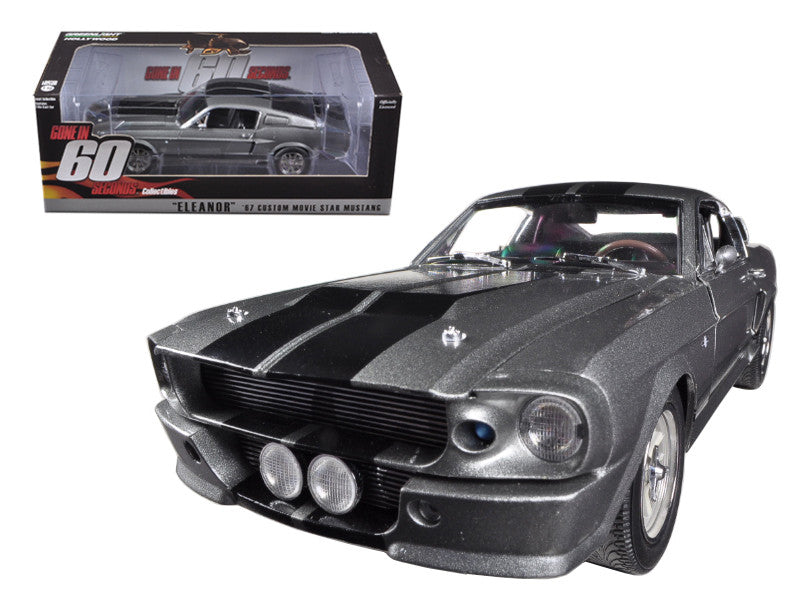 Model car of a classic black Ford Mustang with a clear box in the background